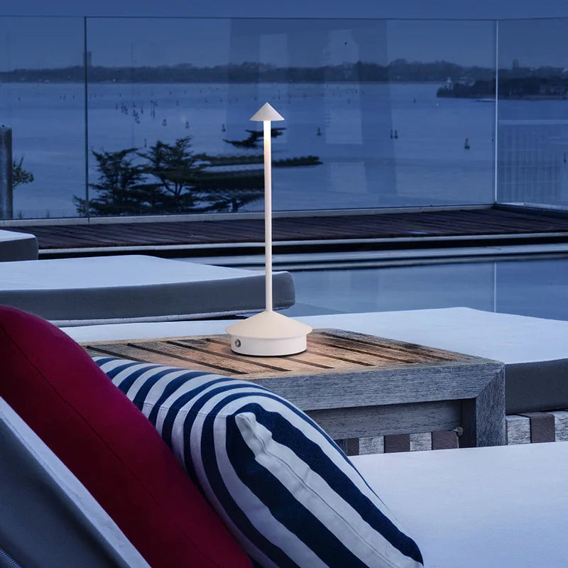 Lampe sans fil Solo blanche sur une table de terrasse face à la mer