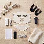 Masque LED Aurore ivoire et ses accessoires sur travertin