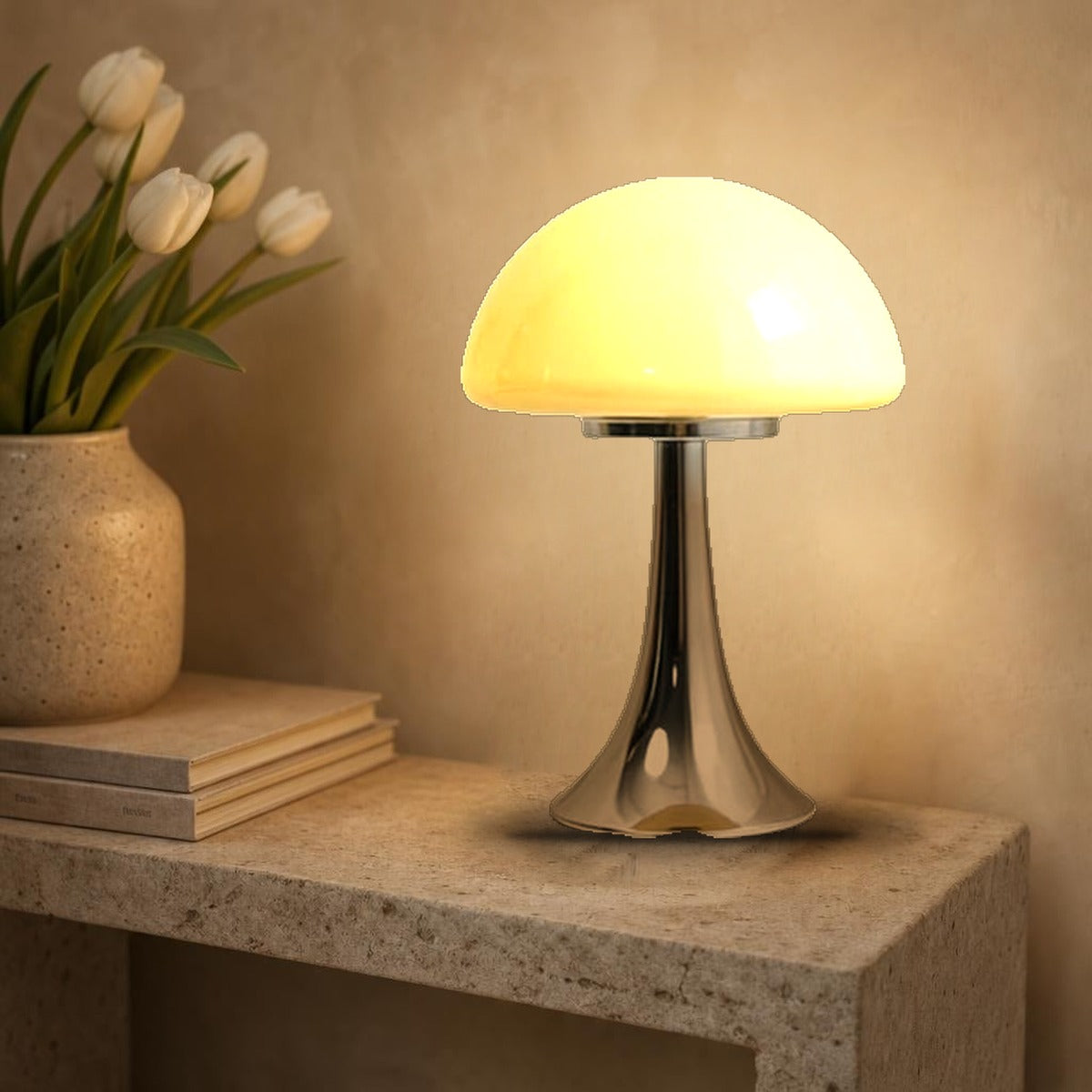 Lampe champignon Polka en verre opalin jaune beurre allumée sur une console en pierre